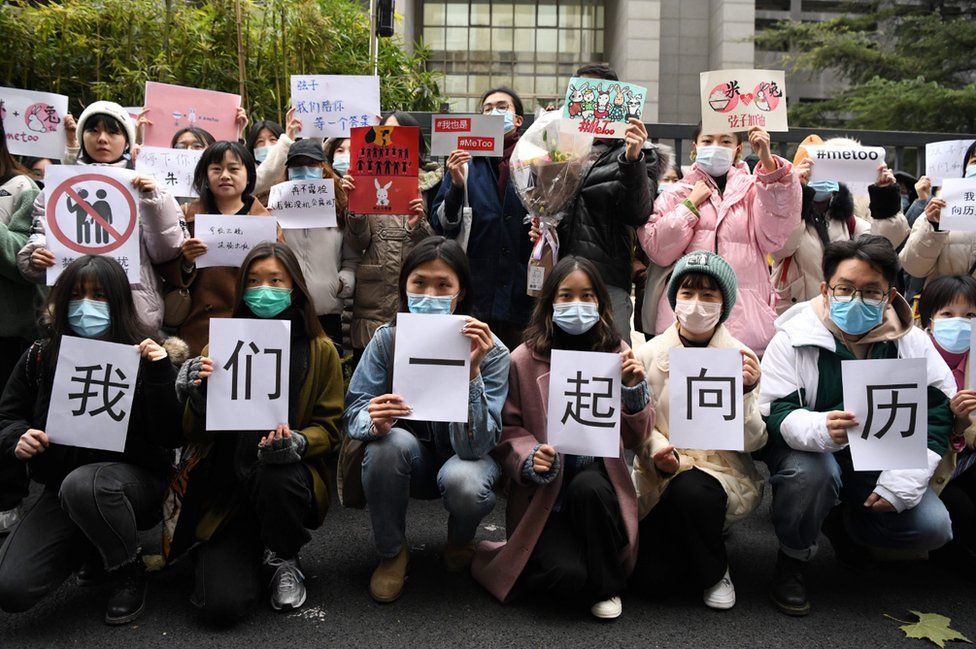 IMAGE SOURCE: AFP Chinese #MeToo activists displaying posters outside court in Beijing